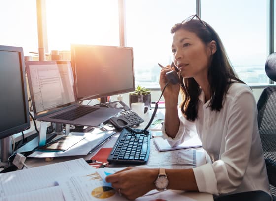 Woman in her office answering the phone